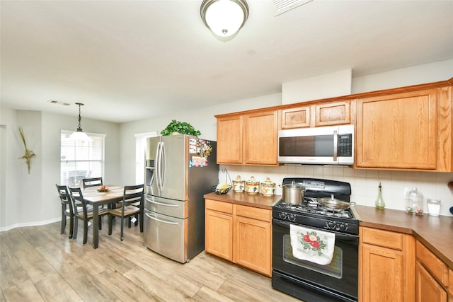 14503 Brackenhurst Ln, Houston, TX 77049 - kitchen with stainless steel appliances, dark countertops, light wood-style flooring, and tasteful backsplash