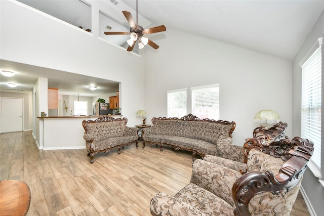 14503 Brackenhurst Ln, Houston, TX 77049 - living room with high vaulted ceiling, a ceiling fan, and light wood-type flooring