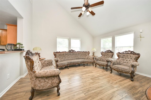 14503 Brackenhurst Ln, Houston, TX 77049 - living room with high vaulted ceiling, a ceiling fan, and light wood-style floors