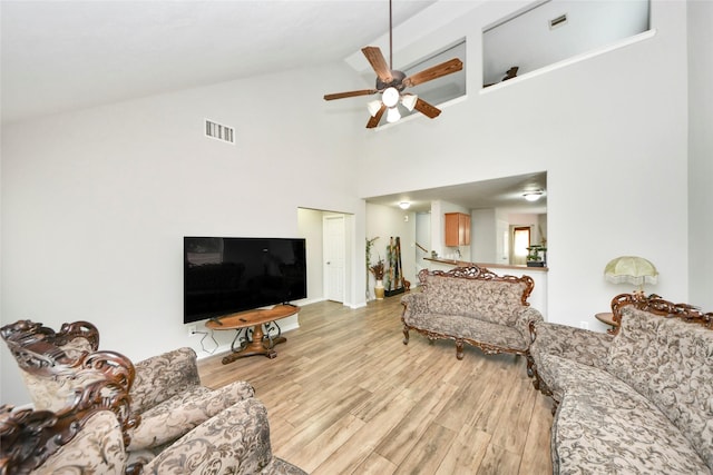 14503 Brackenhurst Ln, Houston, TX 77049 - living area with high vaulted ceiling, light wood-style floors, and ceiling fan