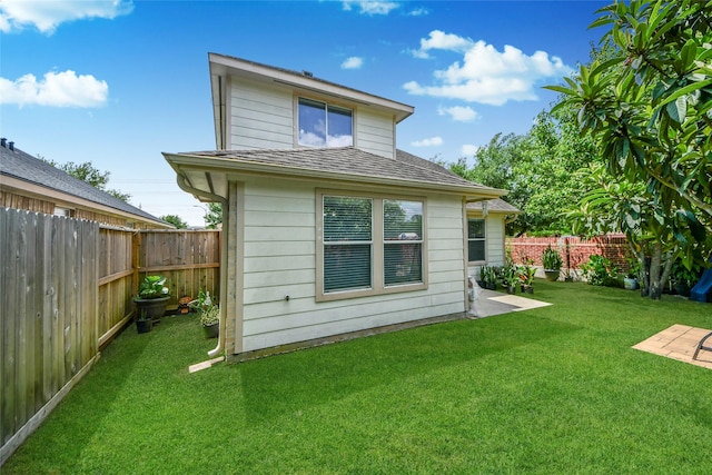 14503 Brackenhurst Ln, Houston, TX 77049 - back of house with a fenced backyard and a shingled roof