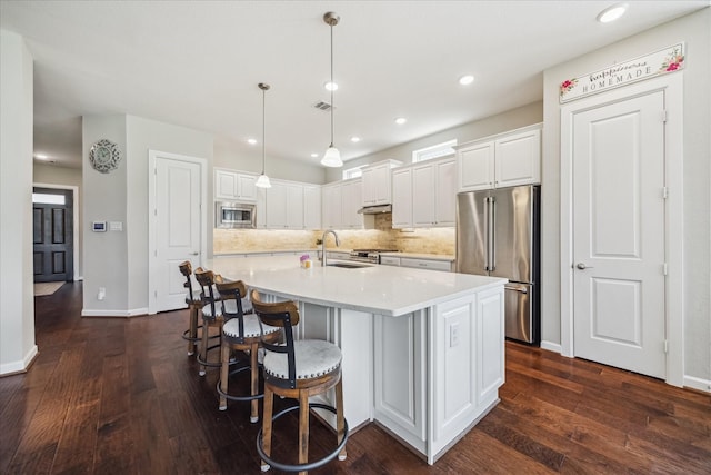 18311 Windspring Falls Ln, Cypress, TX 77433 - kitchen featuring stainless steel appliances, dark wood-style floors, white cabinetry, and recessed lighting
