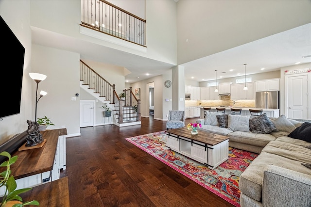 18311 Windspring Falls Ln, Cypress, TX 77433 - living room with dark wood finished floors, stairway, a high ceiling, and recessed lighting