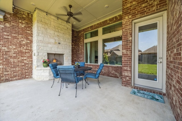 18311 Windspring Falls Ln, Cypress, TX 77433 - view of patio with an outdoor stone fireplace, a ceiling fan, and outdoor dining space