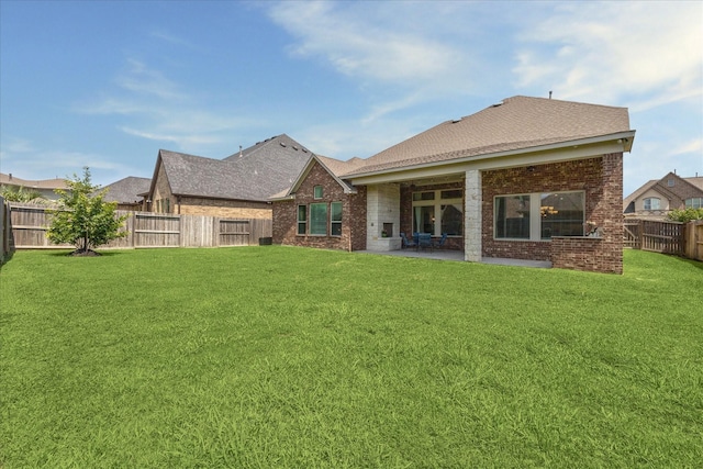 18311 Windspring Falls Ln, Cypress, TX 77433 - rear view of house featuring brick siding, a fenced backyard, a patio, and a shingled roof