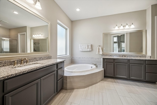 18311 Windspring Falls Ln, Cypress, TX 77433 - bathroom with a shower stall, two vanities, and a bath