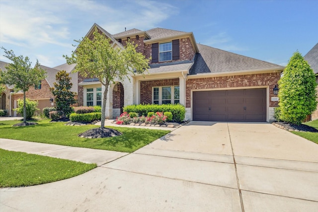 18311 Windspring Falls Ln, Cypress, TX 77433 - view of front of property with brick siding, a garage, concrete driveway, roof with shingles, and a front yard