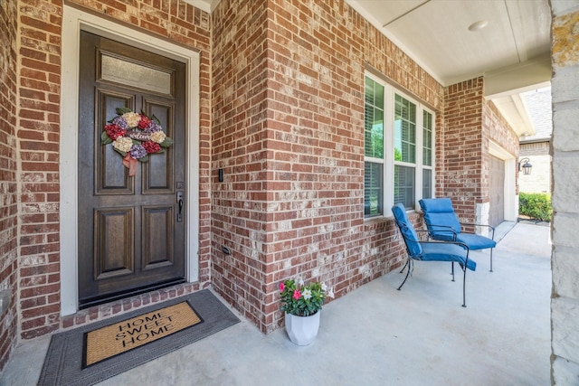 18311 Windspring Falls Ln, Cypress, TX 77433 - doorway to property featuring covered porch, brick siding, and a garage
