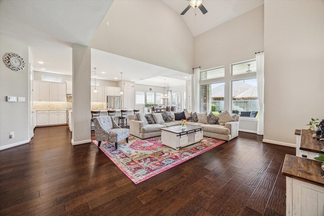 18311 Windspring Falls Ln, Cypress, TX 77433 - living area featuring ceiling fan, dark wood finished floors, vaulted ceiling, and a chandelier