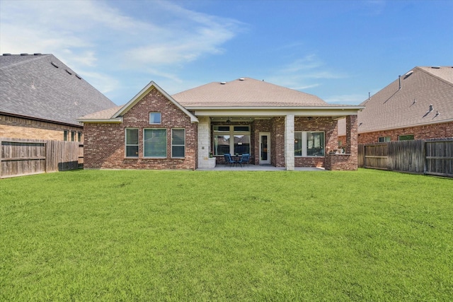18311 Windspring Falls Ln, Cypress, TX 77433 - rear view of house featuring brick siding, a fenced backyard, and a patio area