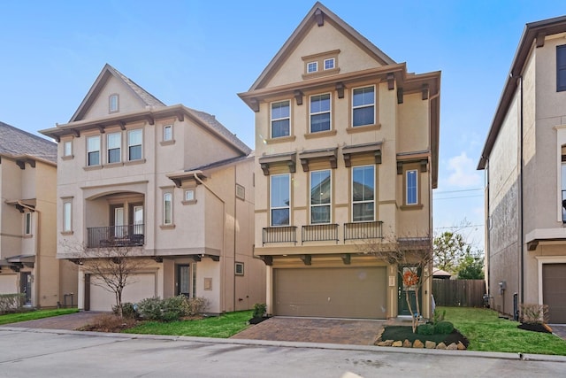 1509 Grayson Oaks Pl, Houston, TX 77043 - view of property with stucco siding, an attached garage, a balcony, and decorative driveway