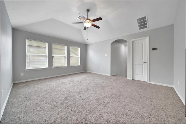 21283 Lily Springs Dr, Porter, TX 77365 - empty room with ceiling fan, arched walkways, carpet flooring, and lofted ceiling