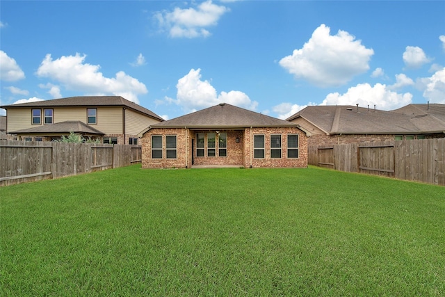 21283 Lily Springs Dr, Porter, TX 77365 - rear view of house with a fenced backyard and brick siding