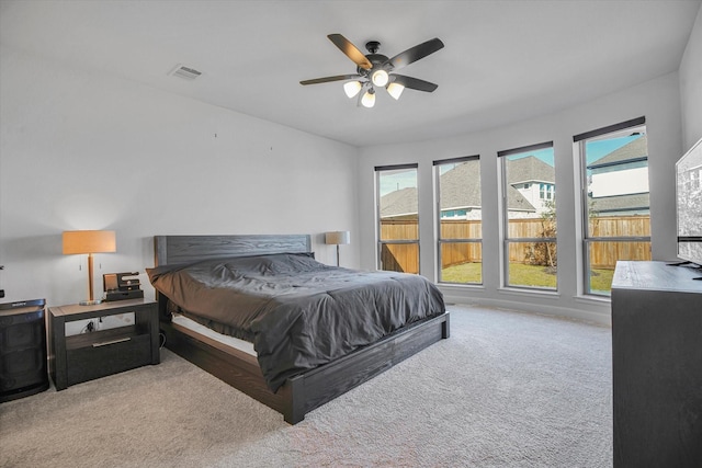 18702 Denio Site Dr, Cypress, TX 77433 - carpeted bedroom featuring multiple windows and ceiling fan