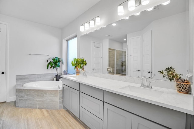 18702 Denio Site Dr, Cypress, TX 77433 - full bathroom featuring double vanity, a stall shower, a bath, and recessed lighting