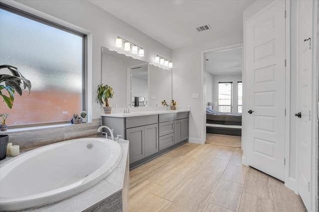 18702 Denio Site Dr, Cypress, TX 77433 - ensuite bathroom with double vanity and a bath