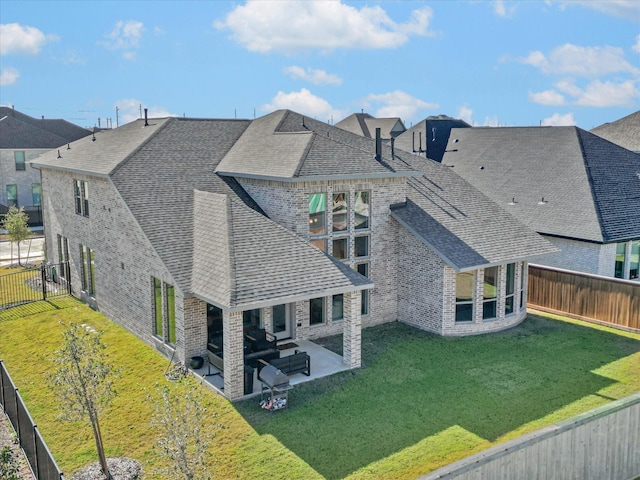 18702 Denio Site Dr, Cypress, TX 77433 - back of property with roof with shingles, a patio area, a fenced backyard, and brick siding