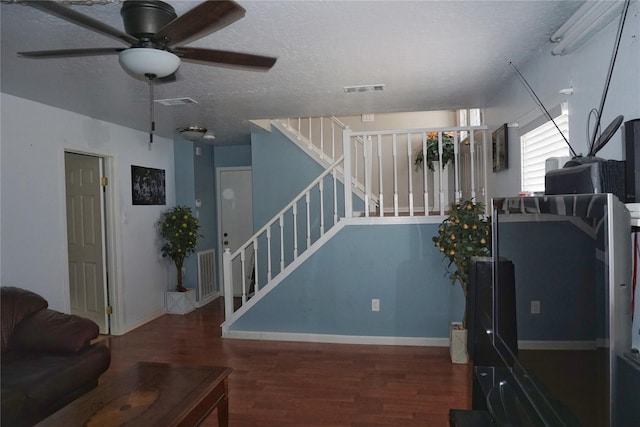 12210 Cliffgate Dr, Houston, TX 77072 - living room featuring a ceiling fan, wood finished floors, stairs, and a textured ceiling