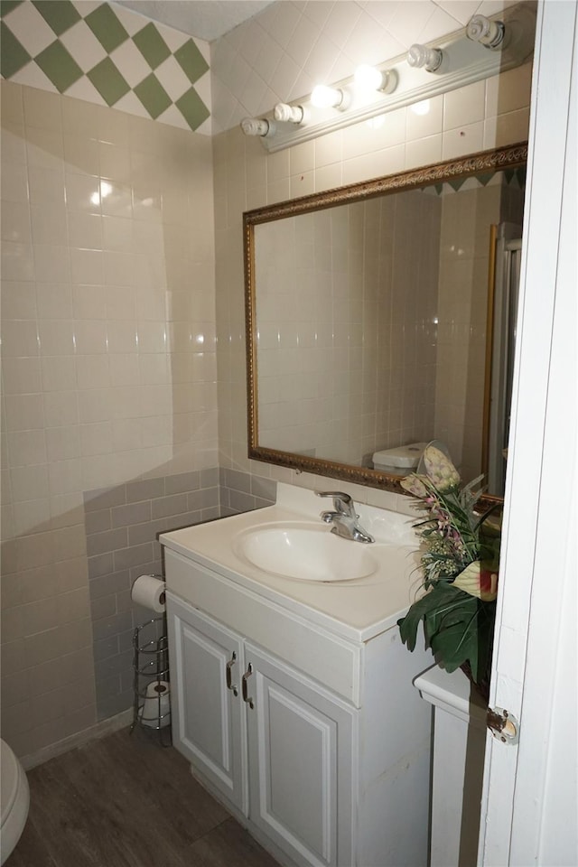 12210 Cliffgate Dr, Houston, TX 77072 - bathroom featuring vanity, tile walls, and wood finished floors