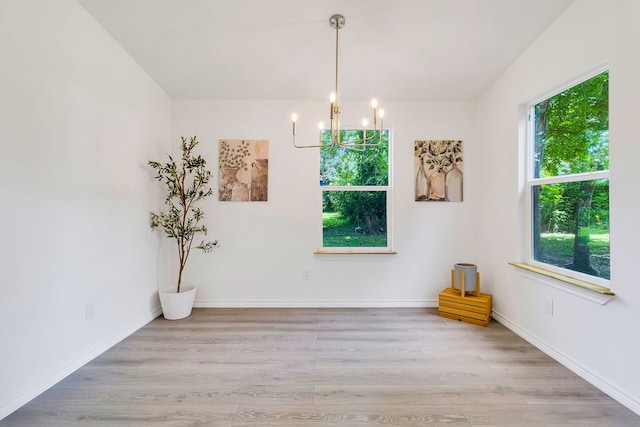 220 Tortuga Way, Point Blank, TX 77364 - unfurnished room featuring a chandelier and wood finished floors