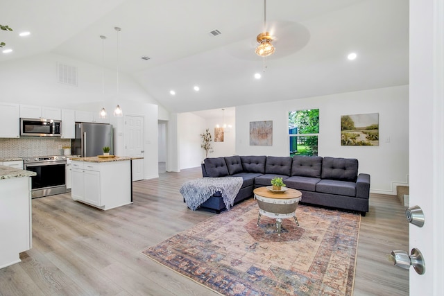 220 Tortuga Way, Point Blank, TX 77364 - living area with light wood finished floors, a ceiling fan, recessed lighting, a chandelier, and high vaulted ceiling