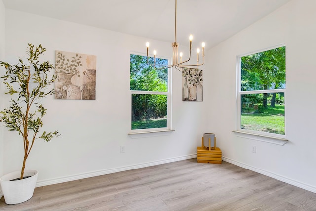 220 Tortuga Way, Point Blank, TX 77364 - spare room featuring light wood-style floors, a chandelier, and plenty of natural light