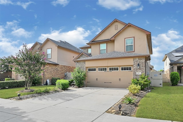 1410 Woods Lake Ct, Houston, TX 77047 - traditional-style home featuring concrete driveway, a front yard, stucco siding, and stone siding