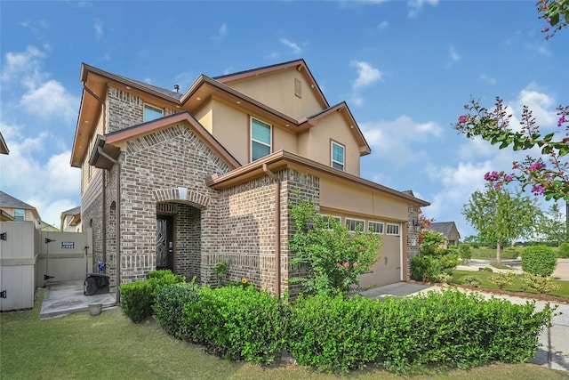 1410 Woods Lake Ct, Houston, TX 77047 - view of front of home with stucco siding, brick siding, and a garage
