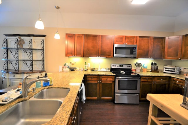 278 Debbie Ln, San Leon, TX 77539 - kitchen with appliances with stainless steel finishes, dark brown cabinets, dark wood-type flooring, pendant lighting, and light stone counters