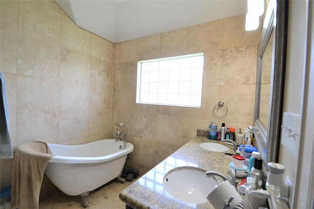 278 Debbie Ln, San Leon, TX 77539 - full bathroom featuring tile walls, a freestanding bath, and double vanity