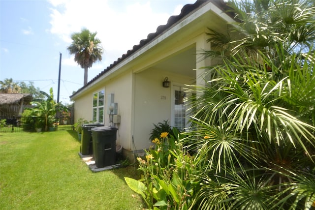 278 Debbie Ln, San Leon, TX 77539 - view of property exterior with a lawn, stucco siding, and a tile roof