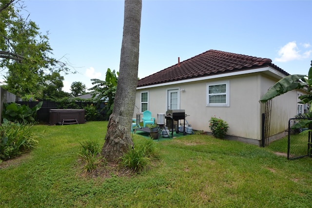 278 Debbie Ln, San Leon, TX 77539 - back of property with a hot tub, a tile roof, and stucco siding