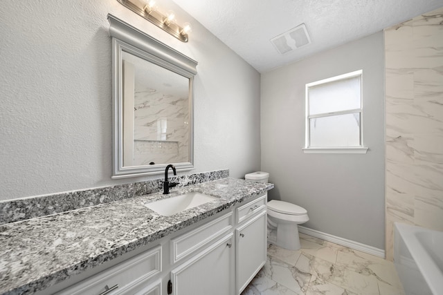 16111 Fan Tail Dr, Crosby, TX 77532 - full bathroom featuring marble look tiles, vanity, and a textured ceiling