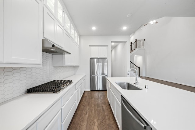 19911 Curved Steel Dr, Cypress, TX 77433 - kitchen with appliances with stainless steel finishes, under cabinet range hood, light countertops, white cabinetry, and recessed lighting