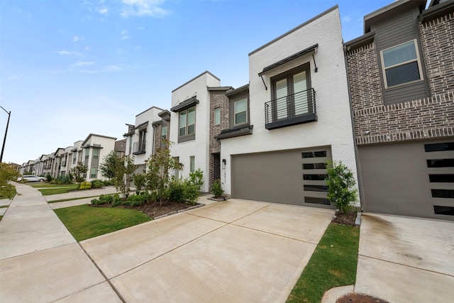 19911 Curved Steel Dr, Cypress, TX 77433 - multi unit property featuring a residential view, an attached garage, a balcony, driveway, and brick siding