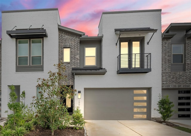 19911 Curved Steel Dr, Cypress, TX 77433 - modern home featuring an attached garage, brick siding, driveway, and a balcony