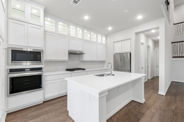 19911 Curved Steel Dr, Cypress, TX 77433 - kitchen featuring stainless steel appliances, dark wood finished floors, backsplash, light countertops, and recessed lighting