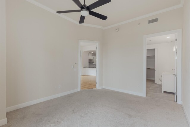 2211 Briarglen Dr Unit 502, Houston, TX 77027 - unfurnished bedroom with carpet flooring, crown molding, a spacious closet, and a ceiling fan