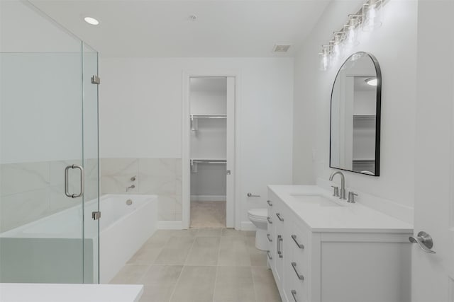 2211 Briarglen Dr Unit 502, Houston, TX 77027 - bathroom featuring a garden tub, vanity, a spacious closet, tile patterned floors, and a shower stall
