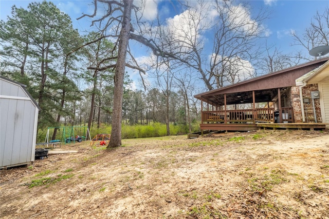 176 Bending Oak, Pollok, TX 75969 - view of yard featuring a trampoline, a wooden deck, and a shed