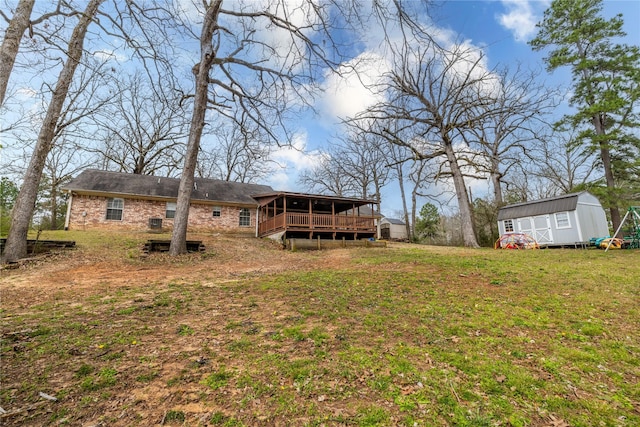 176 Bending Oak, Pollok, TX 75969 - view of green lawn featuring a storage unit and a deck