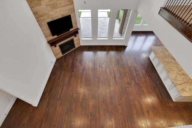 24918 Granite Bluff Ln, Katy, TX 77494 - unfurnished living room featuring dark wood-style floors and a fireplace