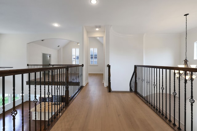 24918 Granite Bluff Ln, Katy, TX 77494 - hall with healthy amount of natural light, wood finished floors, recessed lighting, an upstairs landing, and a chandelier