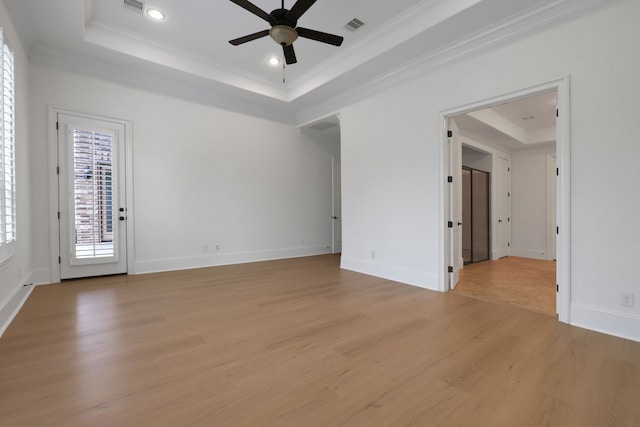 24918 Granite Bluff Ln, Katy, TX 77494 - empty room featuring a tray ceiling, crown molding, ceiling fan, light wood-type flooring, and recessed lighting