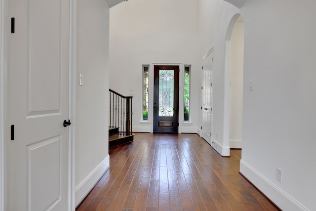 24918 Granite Bluff Ln, Katy, TX 77494 - entryway with arched walkways, wood-type flooring, stairway, and a towering ceiling