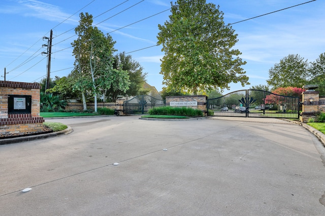 24918 Granite Bluff Ln, Katy, TX 77494 - view of concrete road featuring curbs, a gate, and a gated entry