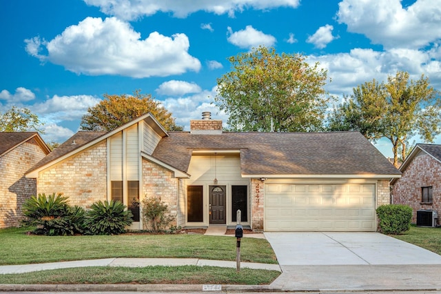2543 Sage Brush Ln, Sugar Land, TX 77479 - mid-century home with a garage, a front yard, driveway, a chimney, and roof with shingles