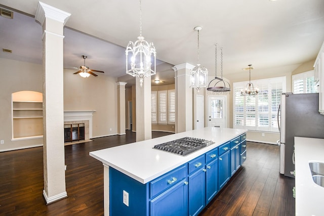 22602 Water Edge Ln, Katy, TX 77494 - kitchen with blue cabinets, appliances with stainless steel finishes, a ceiling fan, dark wood-style flooring, and a chandelier