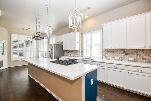 22602 Water Edge Ln, Katy, TX 77494 - kitchen featuring a chandelier, stainless steel appliances, backsplash, a center island, and dark wood-type flooring