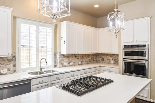 22602 Water Edge Ln, Katy, TX 77494 - kitchen featuring a chandelier, appliances with stainless steel finishes, light countertops, white cabinets, and recessed lighting